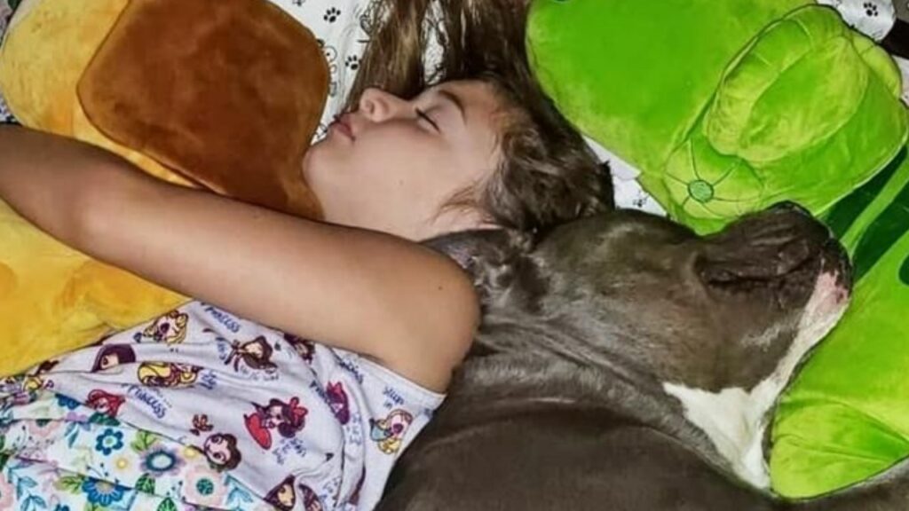 bambina nel letto con il suo cane